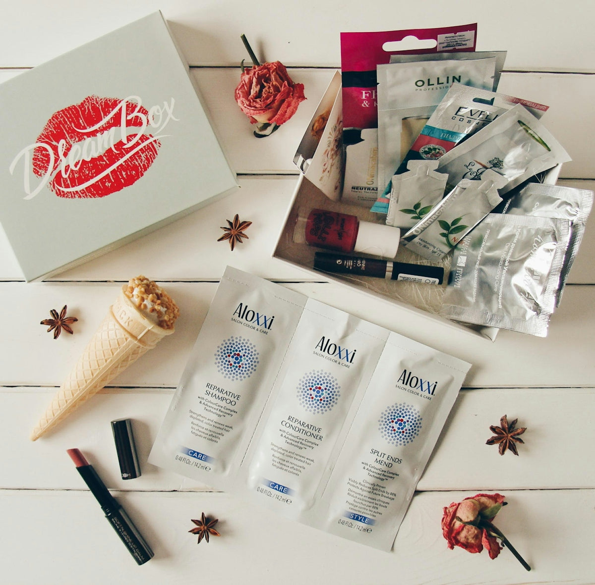 Beauty products and a box on a white wooden surface.