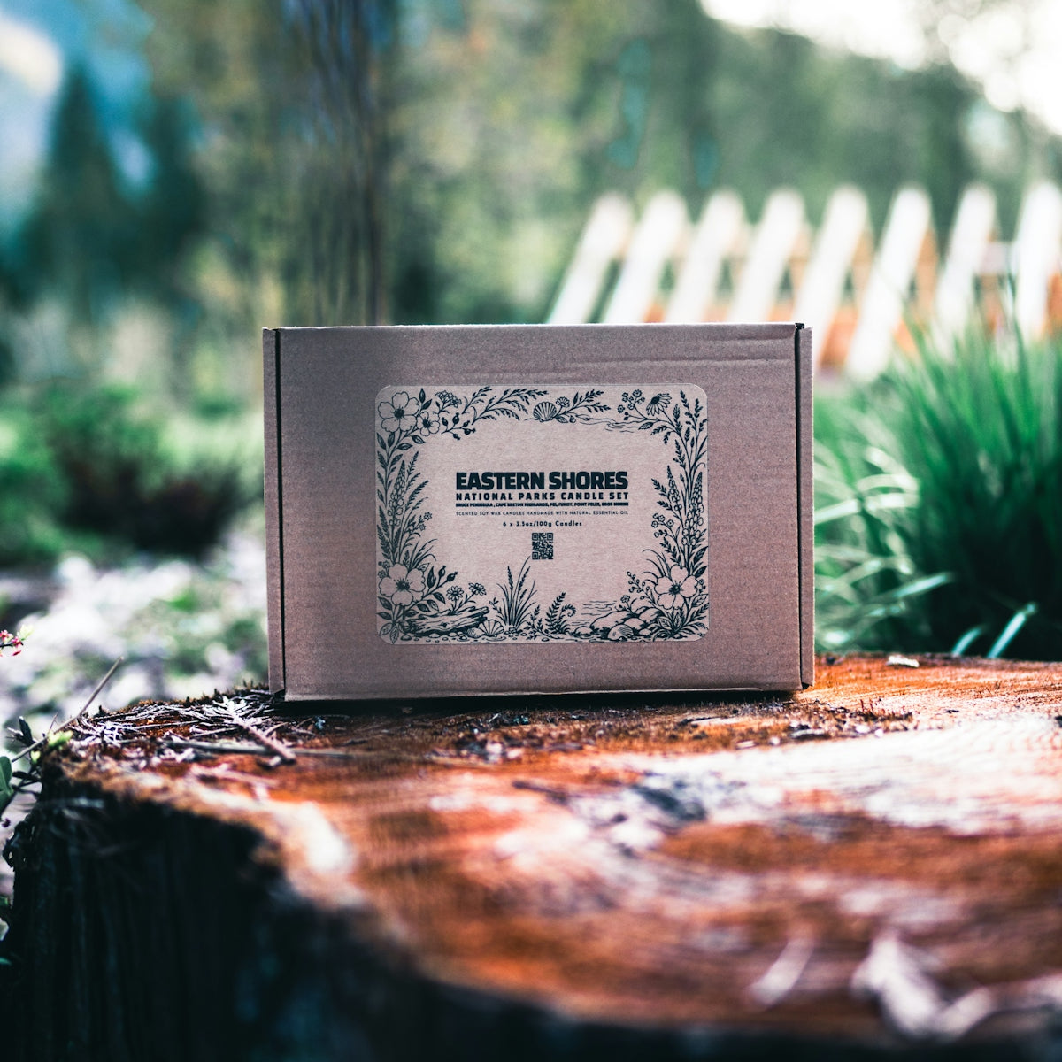 Cardboard box with floral label on tree stump.