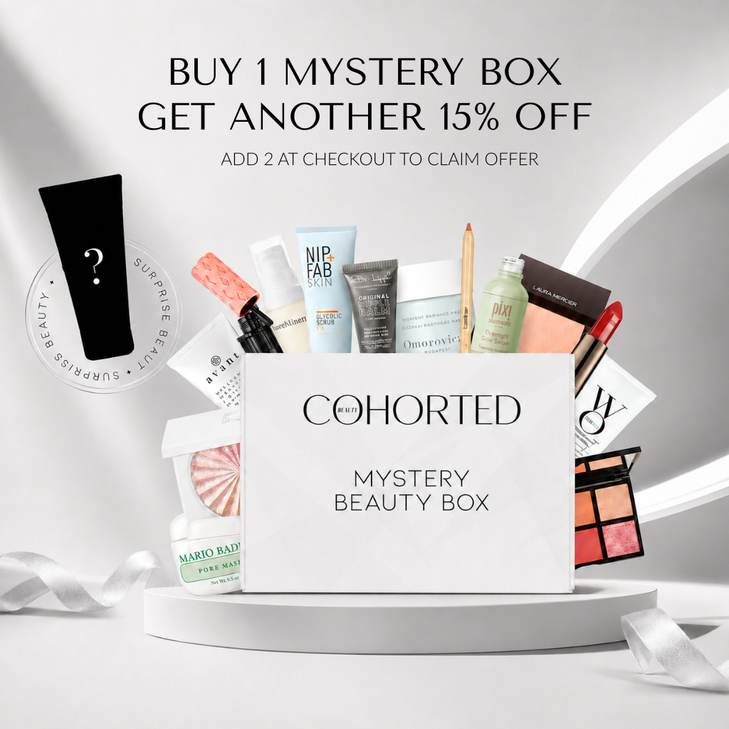 Cohorted First Edition Mystery Beauty Box gift set with assorted skincare and makeup products in a sleek box.